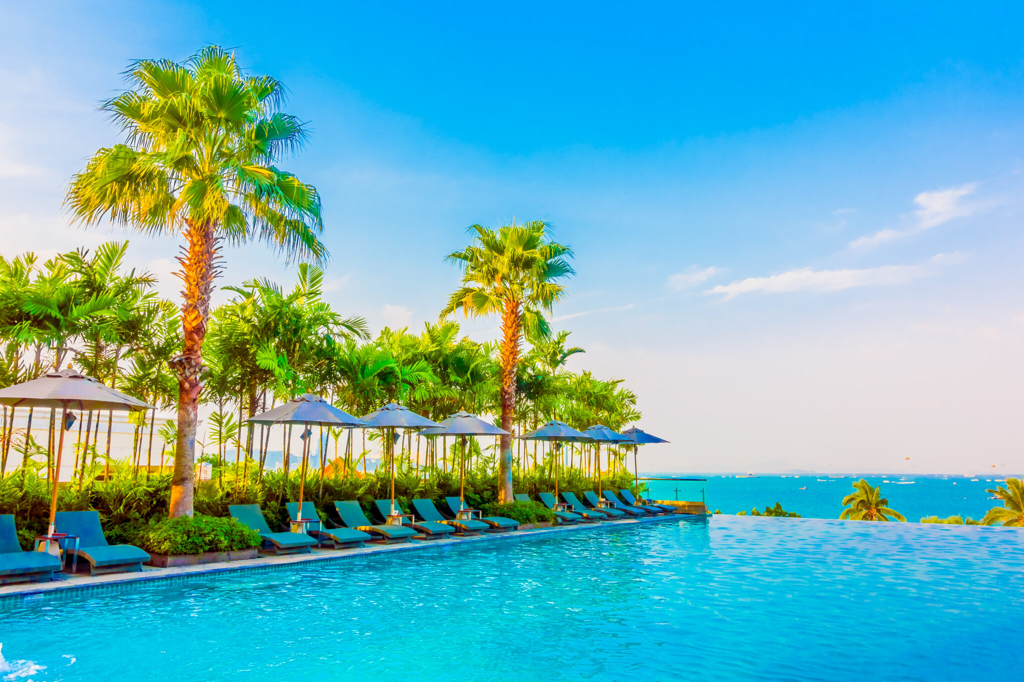 Beautiful luxury swimming pool with umbrella and chair in luxury hotel resort - Boost up color Processing style